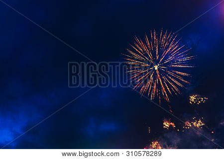 Inexpensive Fireworks Over The City Sky, Red, Blue And White. Bright And Shiny. Selective Focus. For