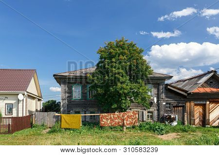 Russian Village In Summer, View Of The Village Street With Old And New Traditional Wooden Houses. Vi