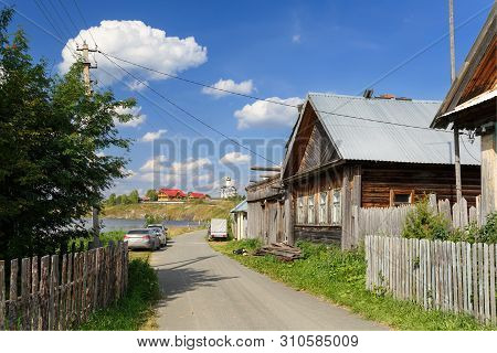 Winding Village Street Along The Lake. View Of The New And Old Wooden Houses. Village Of Visim, Sver