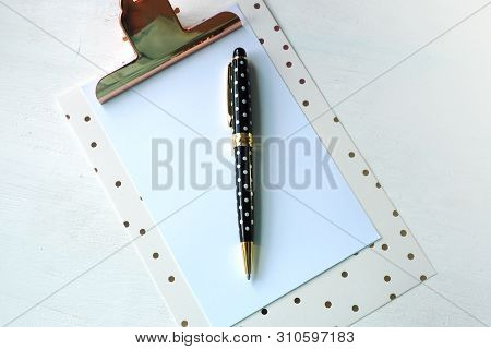 Mock Up Clipboard And Black White Polka Dot Pen On White Table.