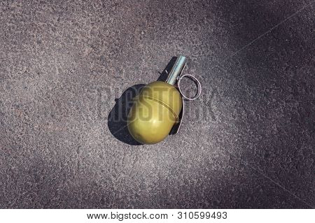 Hand Grenade Rgd-5 On Asphalt. Abandoned Lost Pomegranate Green On The Pavement. Fragmentation Grena