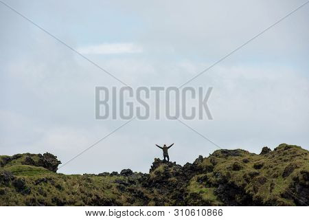 Tourist Posing On The Londrangar Basalt Cliff, Iceland