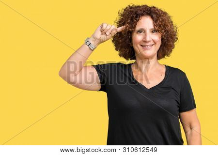 Beautiful middle ager senior woman over isolated background Smiling pointing to head with one finger, great idea or thought, good memory