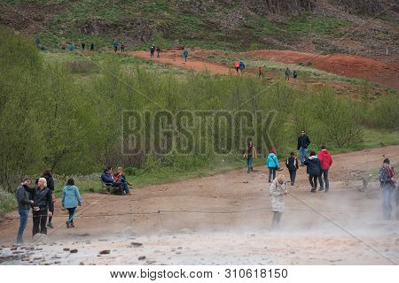 Tourists Visiting Strokkur Geyser In Iceland