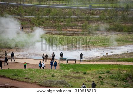 Tourists Visiting Strokkur Geyser In Iceland