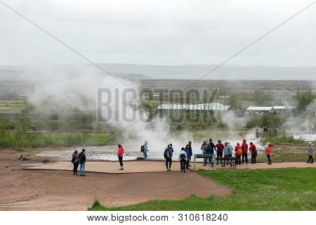 Tourists Visiting Strokkur Geyser In Iceland