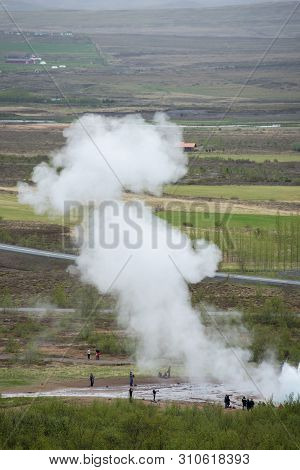 Tourists Visiting Strokkur Geyser In Iceland
