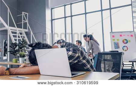 Creative Designer Fall Asleepy While Working Hard With Laptop At Modern Office.workplace Lifesyle Co
