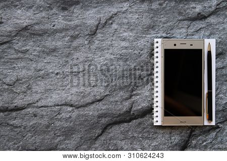 Smartphone Notebook And Paper Wordpad On Stone Background With Copy Space