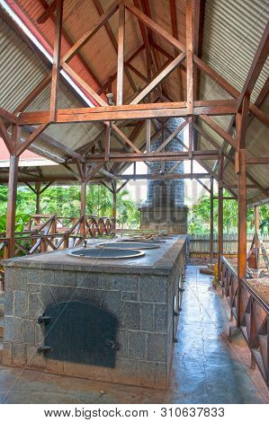 Ancient Small Factory On Rum Distillation  In Sunny Day