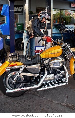 Montreal, Quebec, Canada, September 1, 2018. Woman Refueling A Harley Davidson Motorcycle At A Gas S