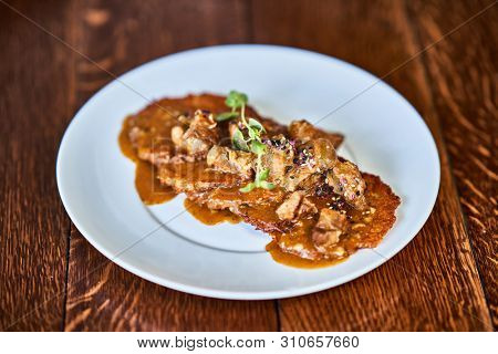 Fried potato pancakes with meat sauce