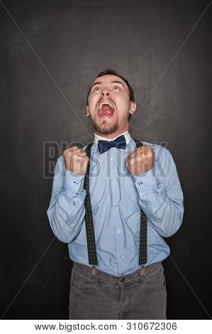 Screaming Happy Business Man With Yes Gesture On Blackboard