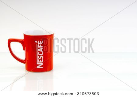 Kuala Lumpur, Malaysia - June 24, 2019:  Promotional Red Nescafe Mug On White Background. Selective 