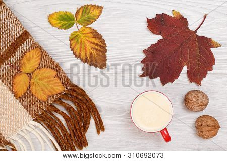 Checkered Plaid, Dry Yellow And Brown Leaves, Cup Of Coffee And Walnuts On Wooden Background. An Aut