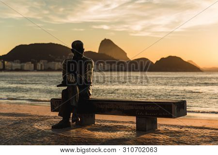 Rio De Janeiro, Brazil - July 1, 2019: Statue Of Brazilian Poet Carlos Drummond De Andrade Sitting O