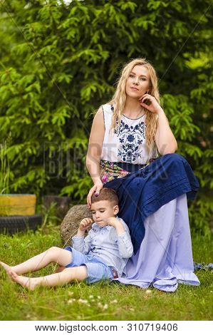 Portrait Of Loving Caucasian Mother With Her Son Outdoors. Posing Against Nature Background.horizont