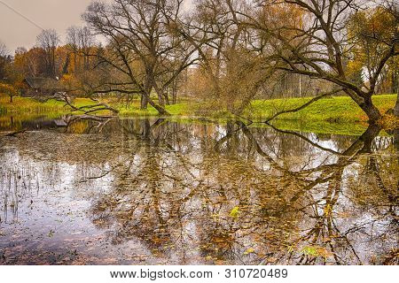 Lonely Wooden House Behind Tranquil Lake In Foreground.hoizontal Image