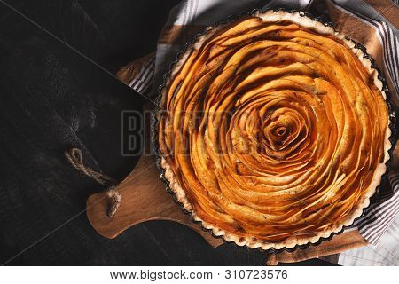 Above View Of A Sweet Potato Pie, In Shape Of A Rose Flower, On A Wooden Cutting Board, On A Rustic 