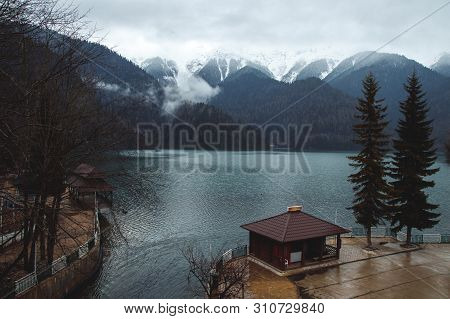 House On Lake Shore Ritsa In Abkhazia Mountains. Cozy Place Away From City. Trees Covered By Snow On