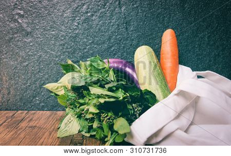Zero Waste Use Less Plastic Concept / Fresh Vegetables Organic In Eco Cotton Fabric Bags On Wooden T