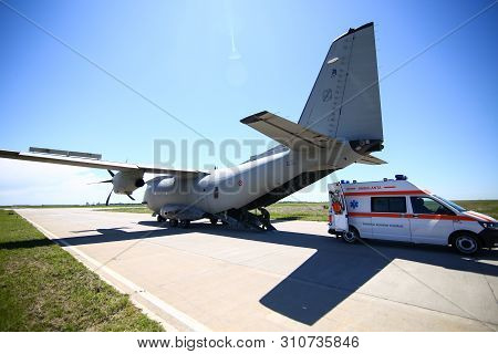 Boboc, Romania - May 22, 2019: An Ambulance Is Parked Near The Rear Exit Of An Alenia C-27j Spartan 