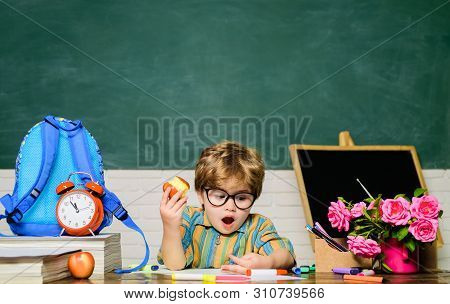 Tasty Food. Small Boy Have School Lunch In Classroom. Little Boy Eat Apple At Lunch Break. Young Sch
