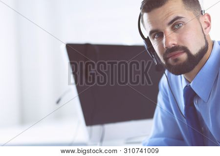 Businessman In The Office On The Phone With Headset, Skype, Facetime