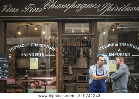 Paris, France - July 11, 2014: Shop Seller Standing In Front Of A Traiteur, A Traditional Parisian C