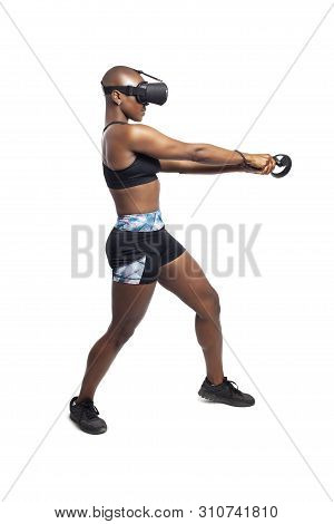Athletic Woman Exercising While Playing Video Game By Practicing Vr Sword Fighting Or Swordplay With