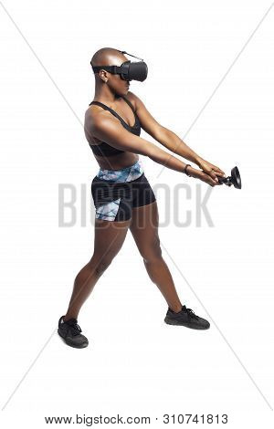 Athletic Woman Exercising While Playing Video Game By Practicing Vr Sword Fighting Or Swordplay With