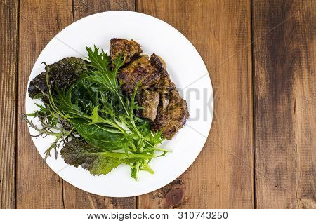 Slices Of Fried Liver, Green Leaves Of Salads