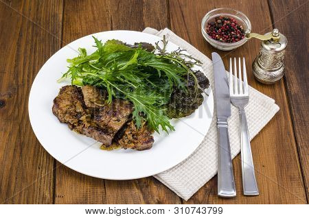 Slices Of Fried Liver, Green Leaves Of Salads