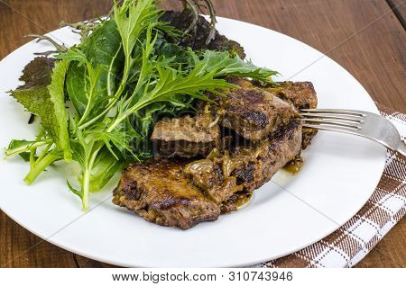 Slices Of Fried Liver, Green Leaves Of Salads