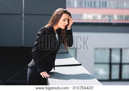 Anxious Businesswoman, Suffering From Acrophobia, Standing On Rooftop And Looking Down