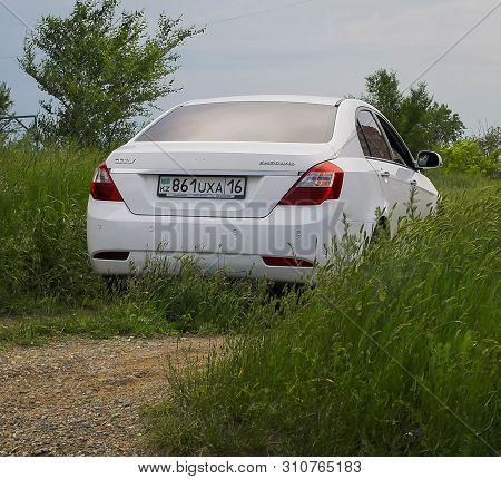 Kazakhstan, Ust-kamenogorsk, April 14, 2019: Chinese Car Geely Emgrand Parked In Green Grass