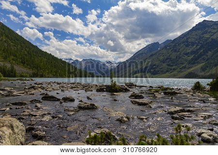 Multinsky Lakes In Altai Mountains. Picturesque Landscape With Huge Stonen, Clouds And Blue Water.