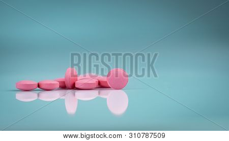 Round Pink Tablets Pill On Gradient Background. Vitamins And Minerals Plus Folic Acid Vitamin E And 