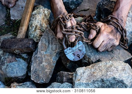 The Hands Of A Slave In An Attempt To Release. The Symbol Of Slave Labor. Hands In Chains.