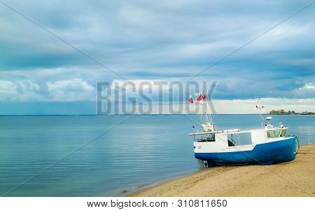 Fishing Boat On Baltic Sea Coast. Stormy Weather. Mechelinki, Poland, Pucka Bay.