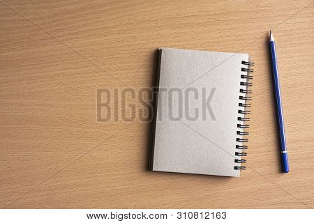Notepad With Pencil On Wood Board Background.using Wallpaper For Education, Business Photo.take Note