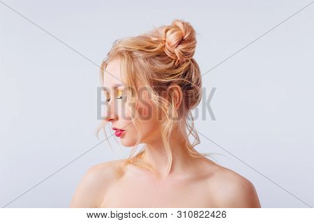 Young Blonde Girl With An Original Hairstyle And Bright Professional Makeup