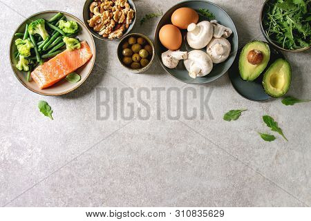 Ketogenic Diet Ingredients For Cooking Dinner. Raw Salmon, Avocado, Broccoli, Bean, Olives, Nuts Mus