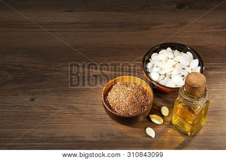 Flax And Pumpkin Seeds On A Wooden Table
