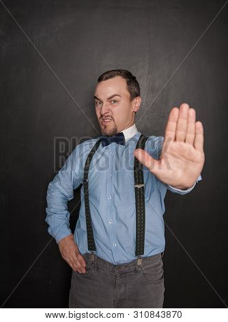 Handsome Business Man With Stop Gesture On Blackboard