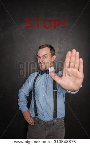 Handsome Business Man With Stop Gesture On Blackboard