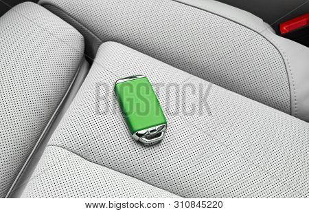 Closeup Inside Vehicle Of Wireless Green Leather Key Ignition On White Leather Seat. Wireless Start