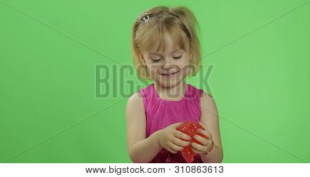 Child Having Fun Making Red Slime. Kid Playing With Hand Made Toy Slime. Funny Kid Girl. Relax And S