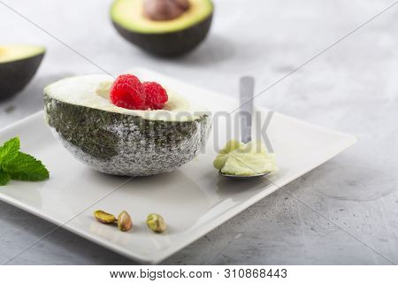 Homemade Organic Avocado And Pistacho Ice Cream With Raspberries