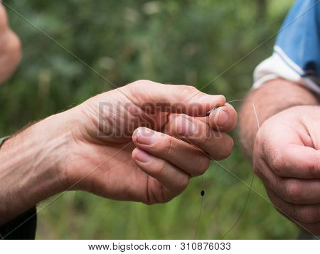 Man Clings To Fishing Line Close Up